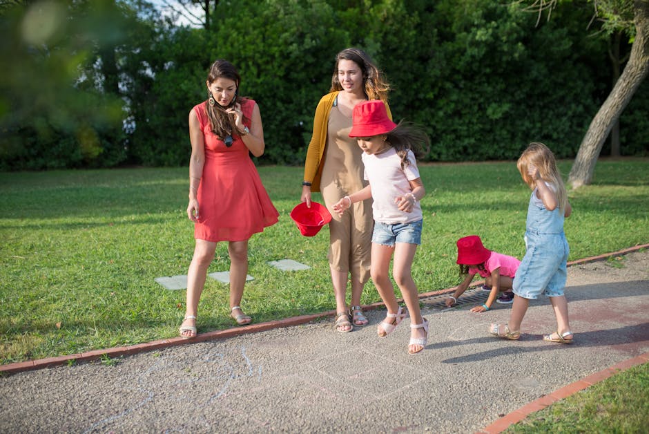 A joyous family experience in a lush Portugal park, featuring playful activities between young girls and adults.